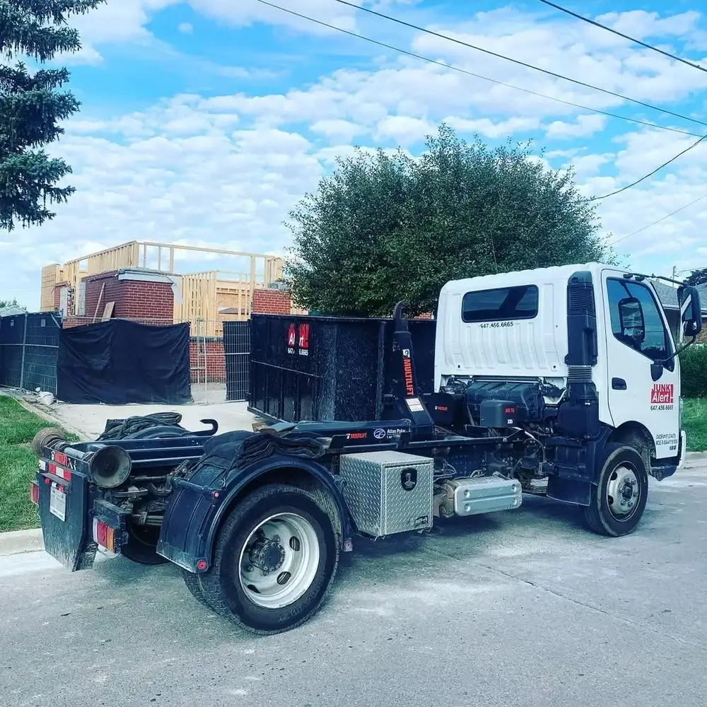 Junk Alert roll-off truck carrying a bin