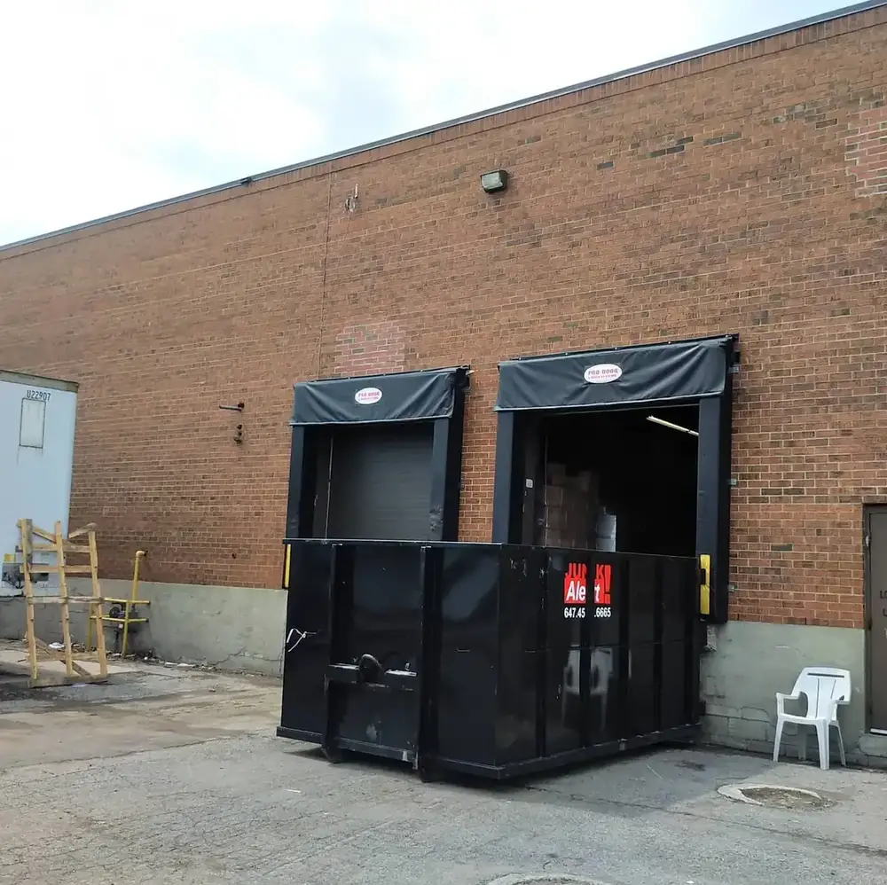 Bin placed at a loading dock behind a commercial unit