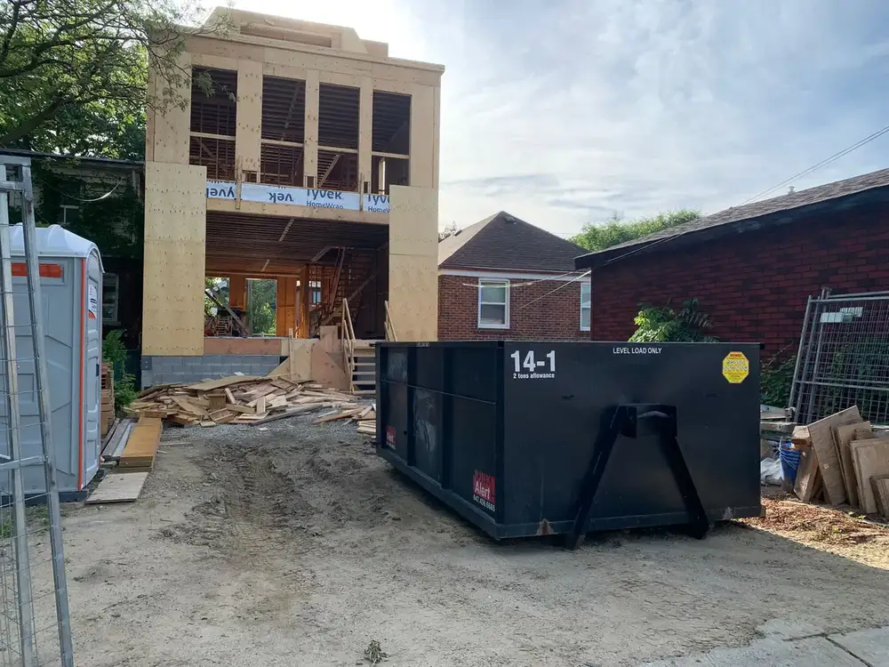 Bin beside a new build behind site fencing