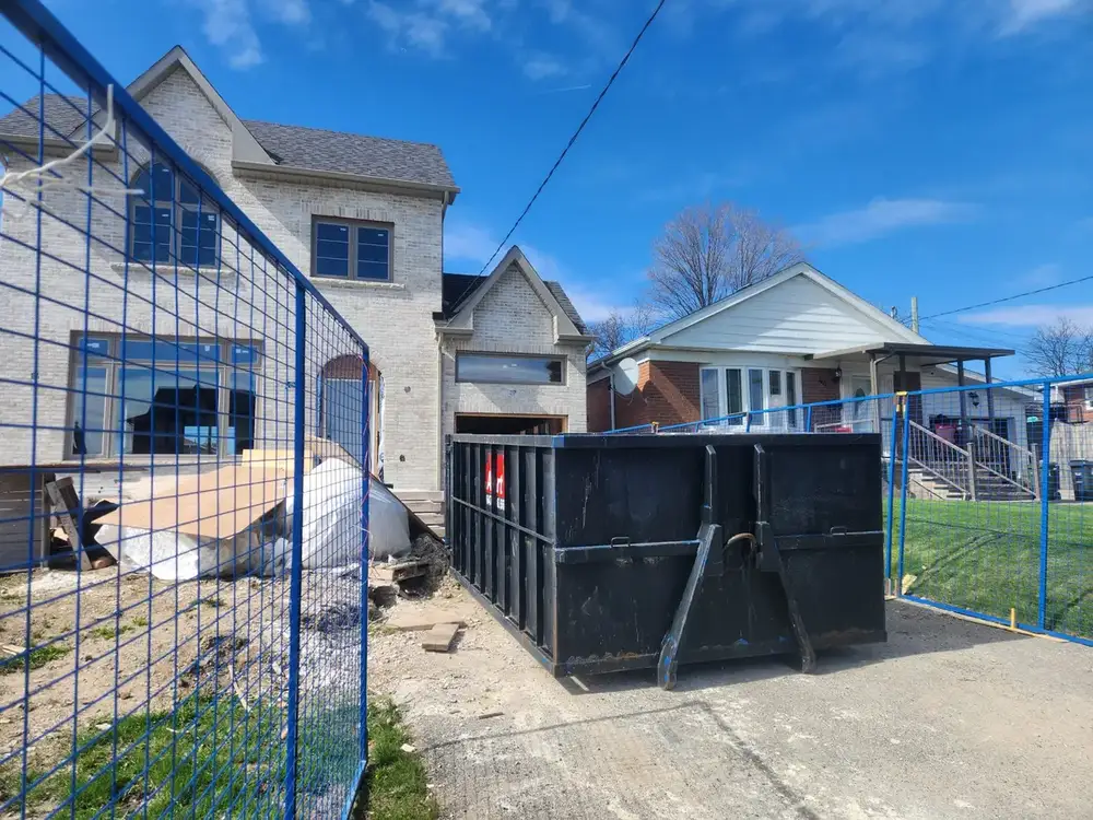 Bin behind construction fencing on a residential street