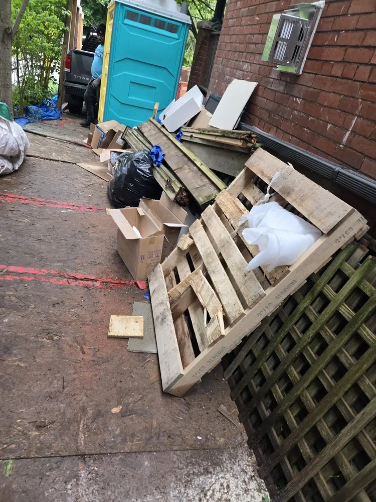 Before: Pallets and site waste cleared from a side path